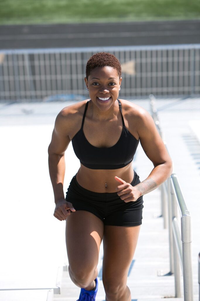 Woman running up outdoor stairs.