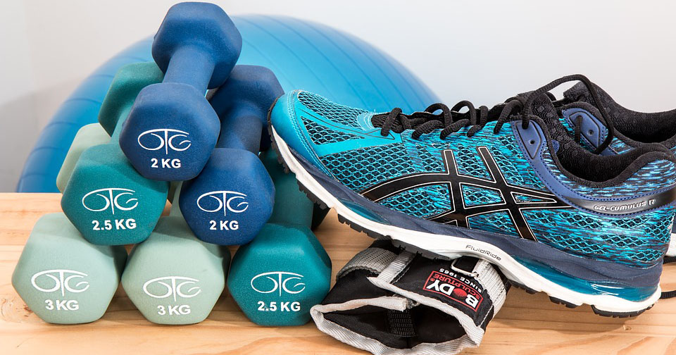 Stack of small dumbbells with gym shoes.