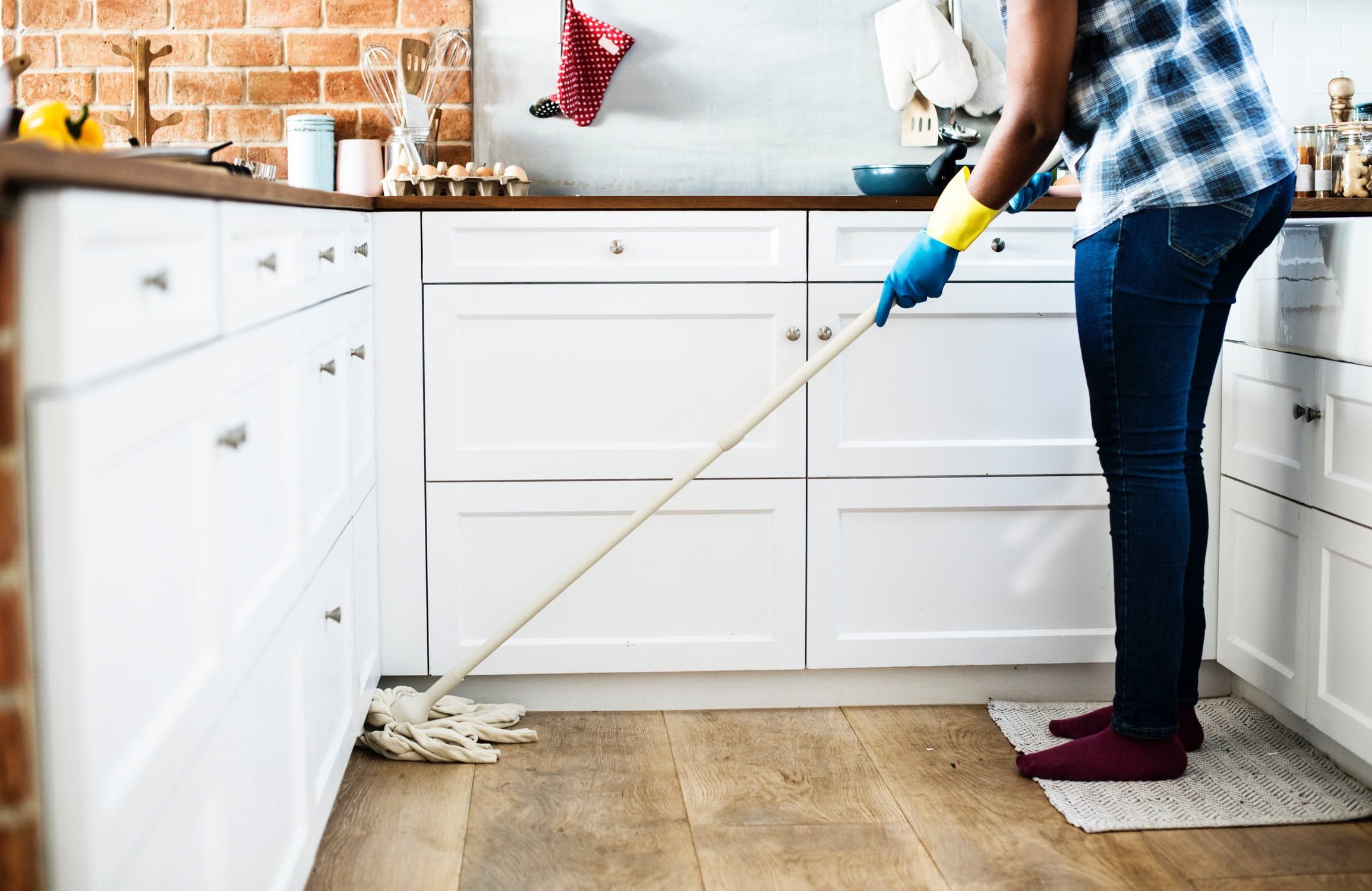 Person mopping their kitchen floor.