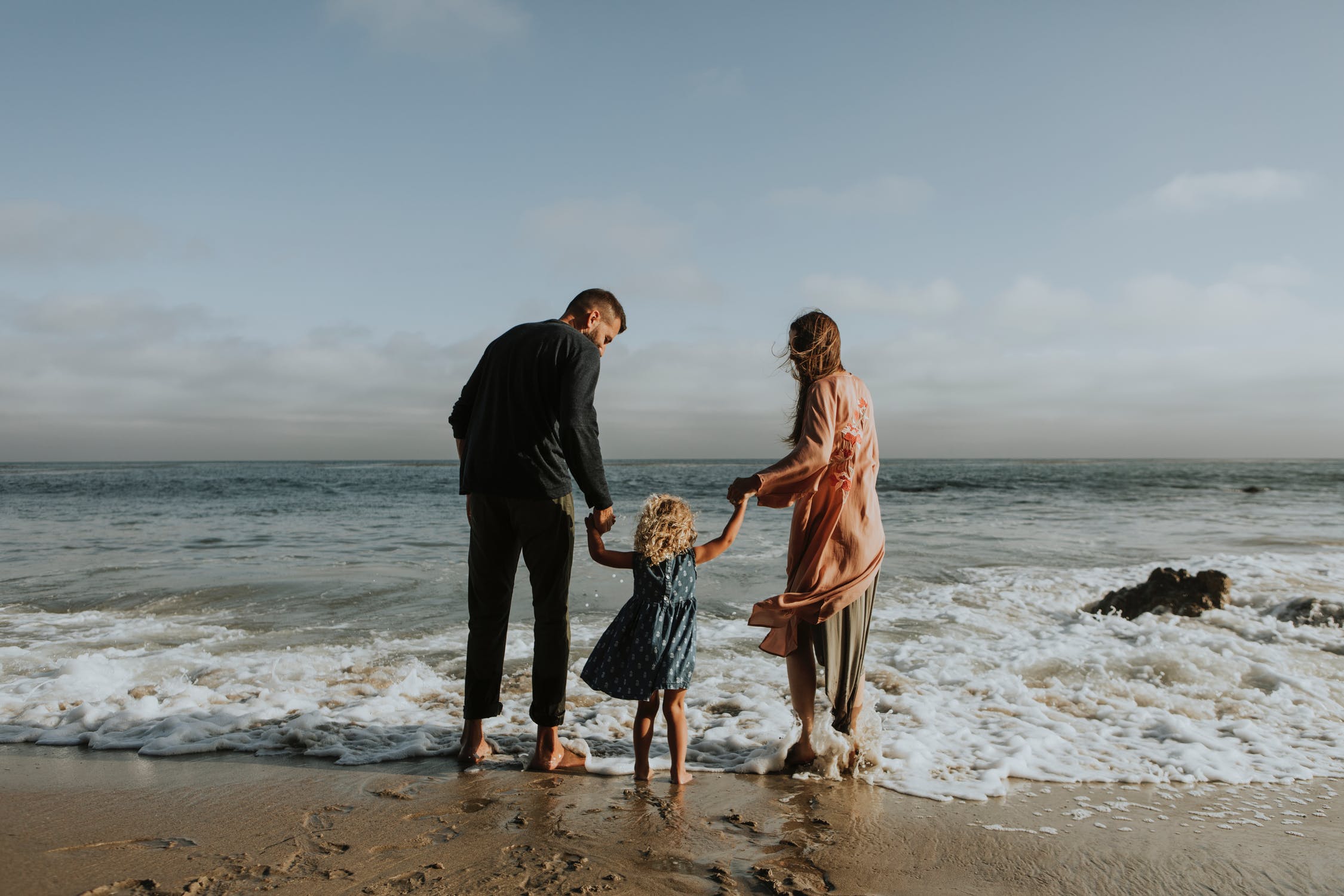 Family with small child on the beach.