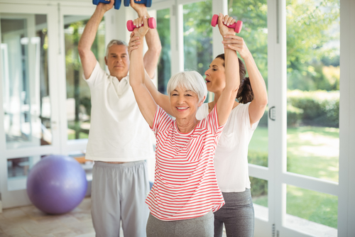 Older people exercising with trainer.