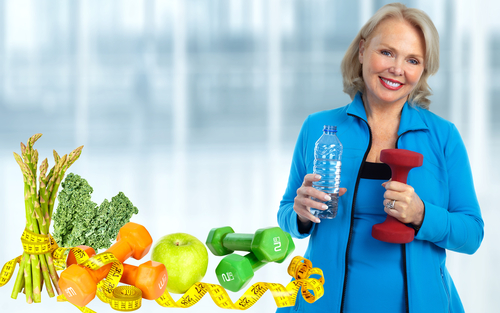 Older women holding water bottle and dumbbell next a measuring tape and fruits an veggies.