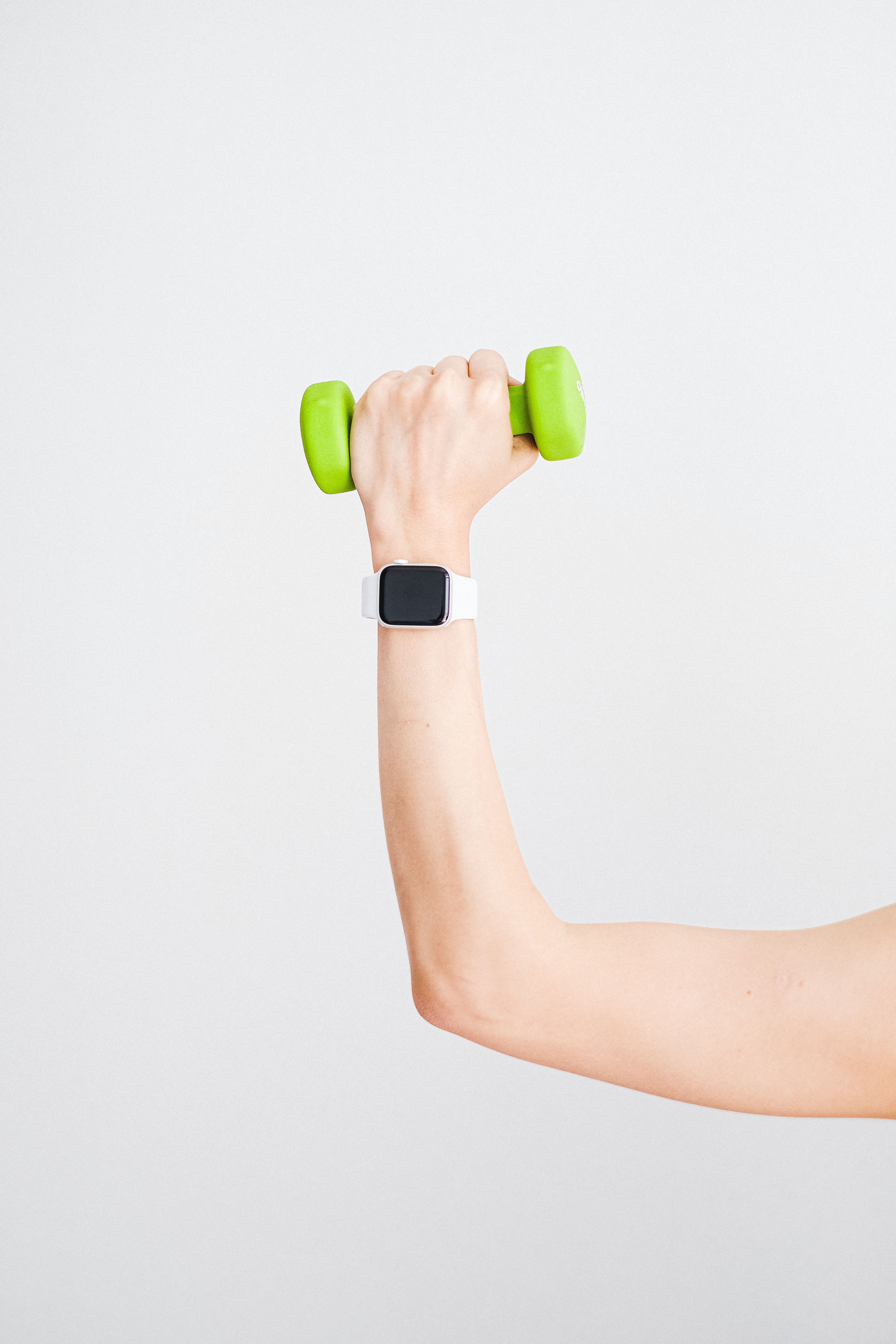 Person holding dumbbell in air.