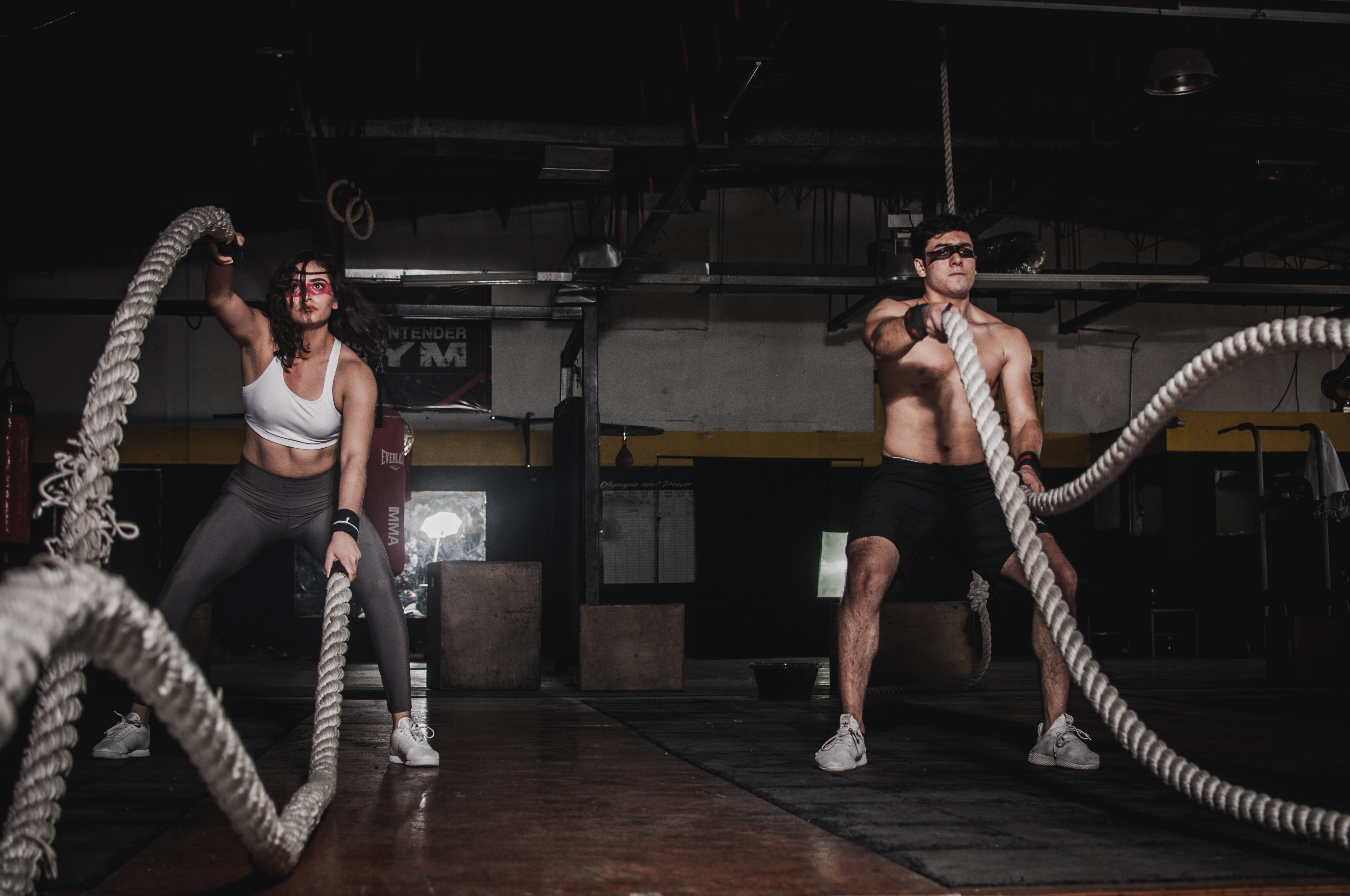 Two people working out with ropes.