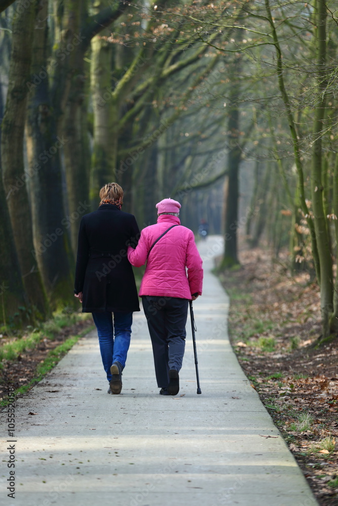 Older couple walking in park.