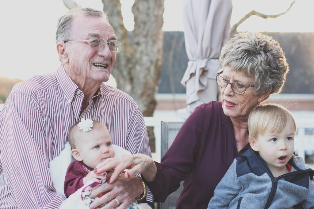 Older couple with infant and toddler.