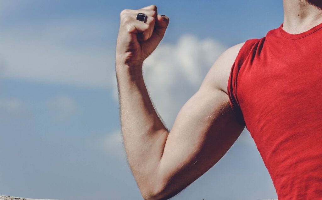 Close-up of man flexing bicep.