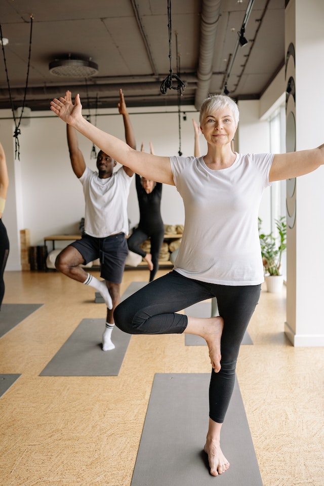 Older woman in yoga class.