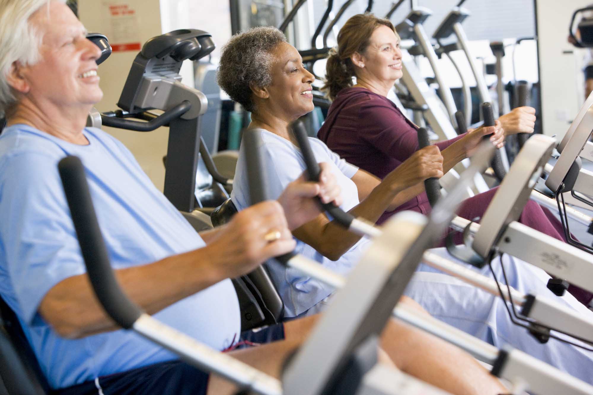 Older people exercising in a gym.