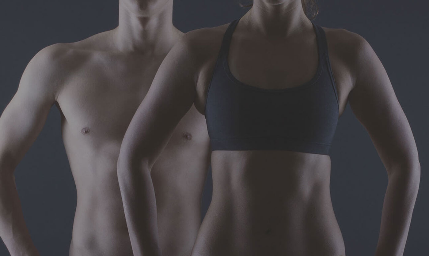 Woman in front of man, both showing off torso muscles.