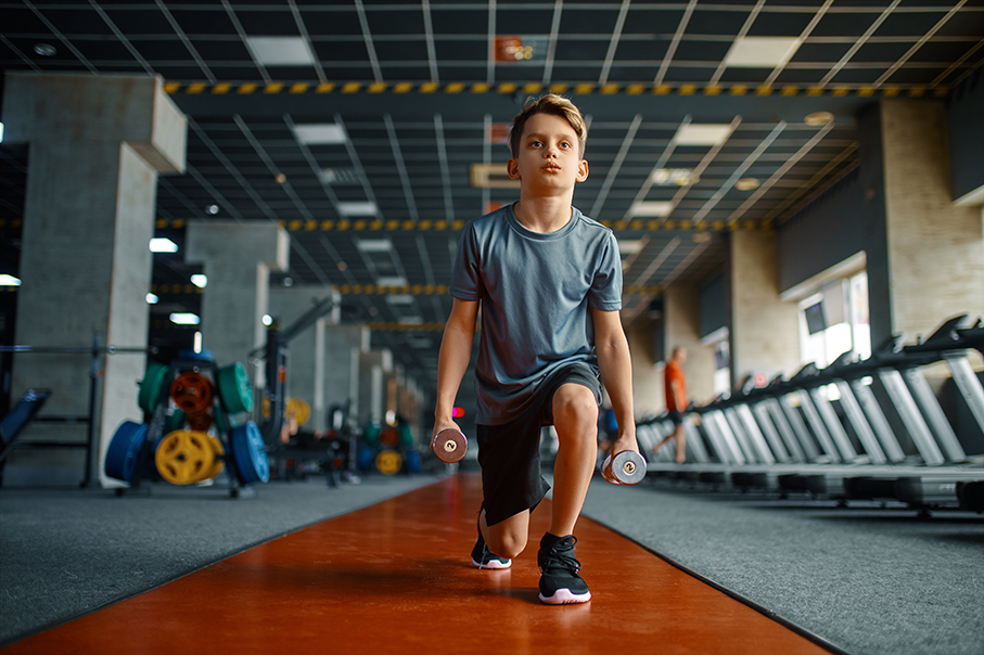 young kid doing lunges with 2 lb dumbbells
