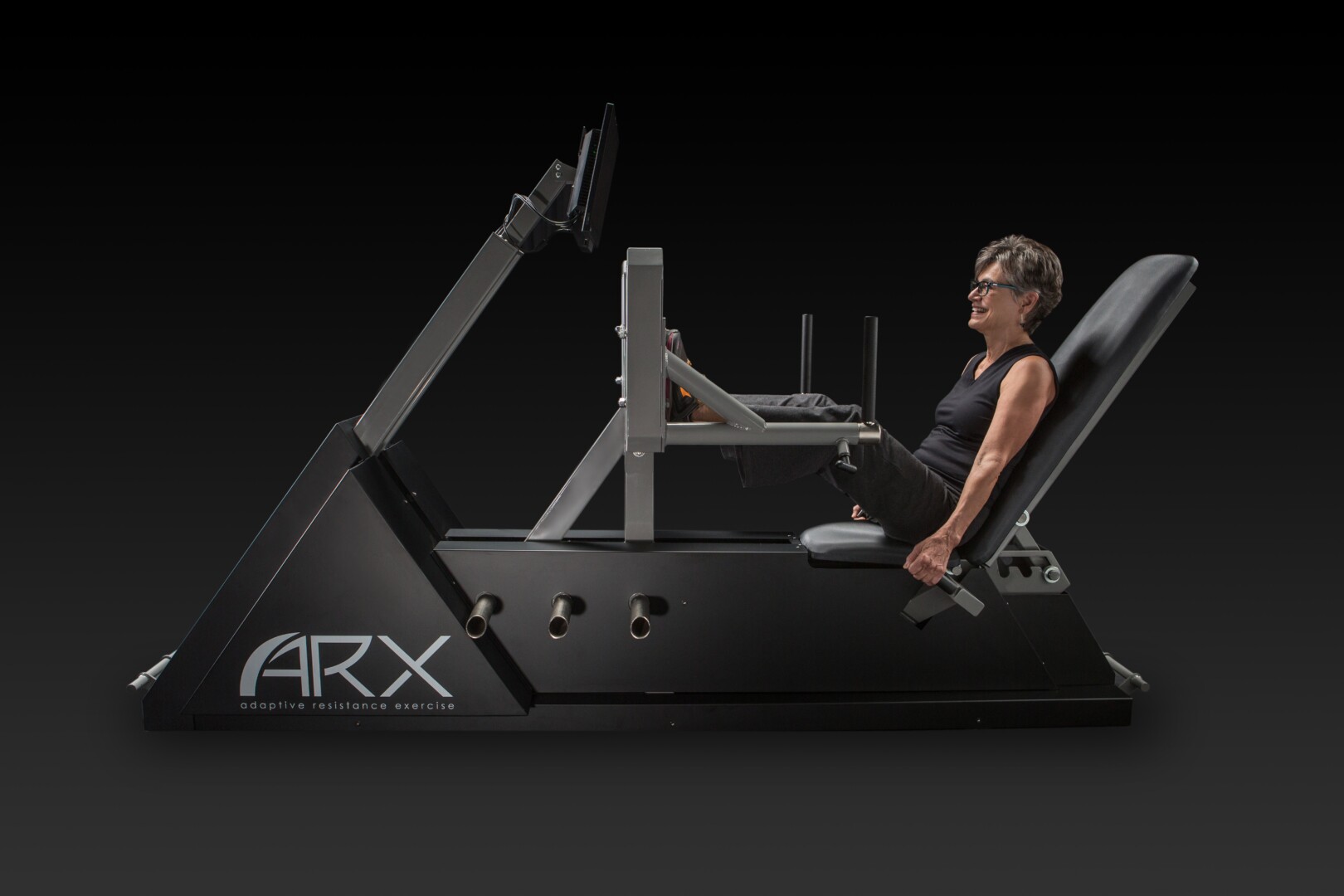 Woman using ARX adaptive resistance exercise machine for leg press workout