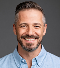 a headshot of a middle aged man smiling at the camera