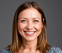 a headshot of a middle aged woman smiling at the camera